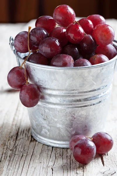 Black grapes on rustic wood — Stock Photo, Image