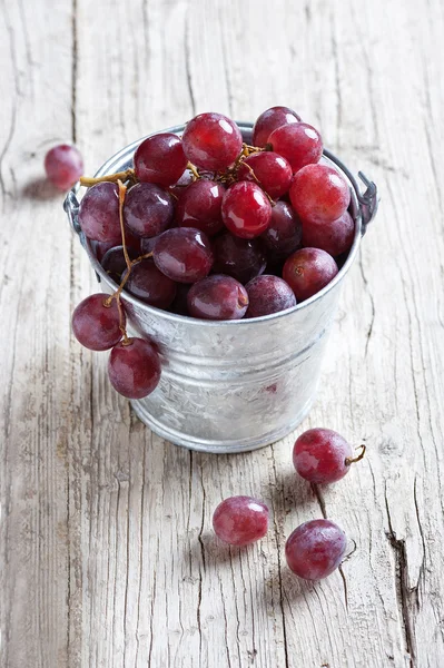 Black grapes on rustic wood — Stock Photo, Image