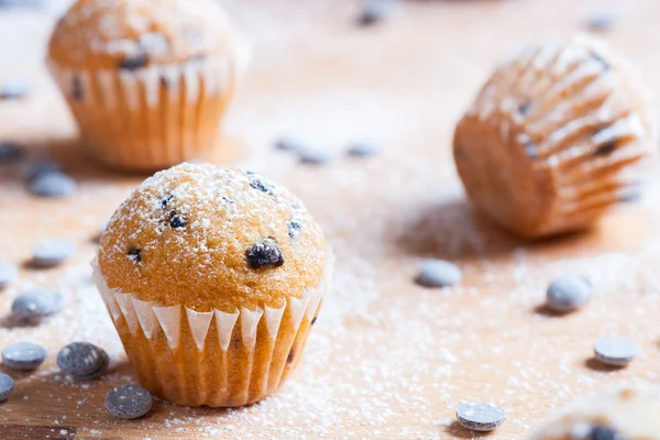 Muffins au chocolat isolés au premier plan sur table rustique en bois — Photo