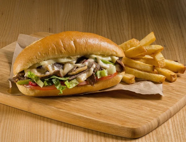 Cheesesteak sandwich on cutting board — Stock Photo, Image