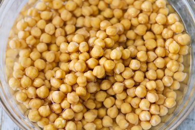 Chickpeas soaked in a glass bowl to make a stew