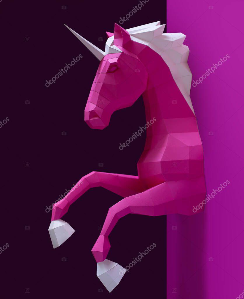 Pink paper geometric unicorn head. Made of paper. Innovative interior design details. Original geometric shape.