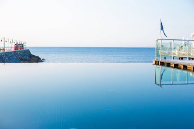 Huzurlu bir sonsuzluk havuzu okyanus ufkuyla kusursuz bir şekilde harmanlanır, minimalist çizgiler ve sakin bir atmosferle..