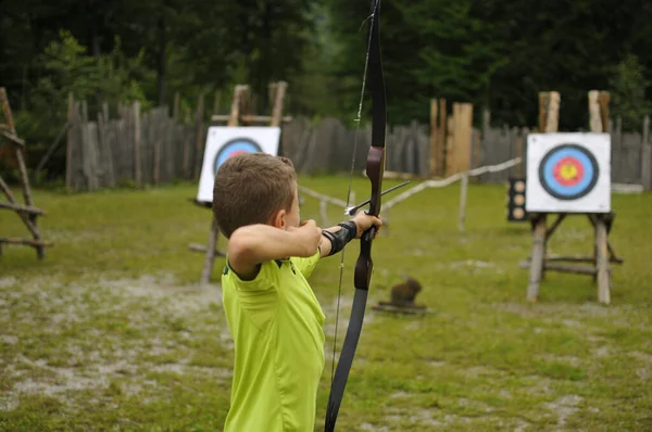 Boy at archery with bow and arrow