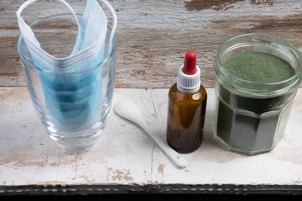 Mouth guard with glass spoon and green superfood powder