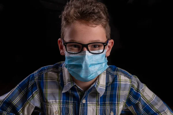 Boy with glasses and shirt and mouth mask