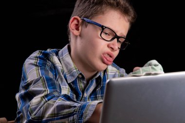 Boy dusts laptop with green cloth clipart