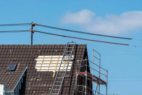 Roofing work with power cable and ladder