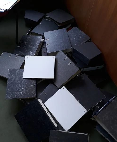 empty file folders on the floor of the office