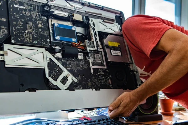 Technician repairing desktop in office