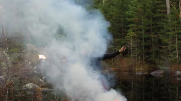 Genç adam ateş çubuğu ve dumanla dans ediyor. — Stok video