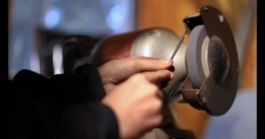 Dönen değirmen taşında parlayan eller