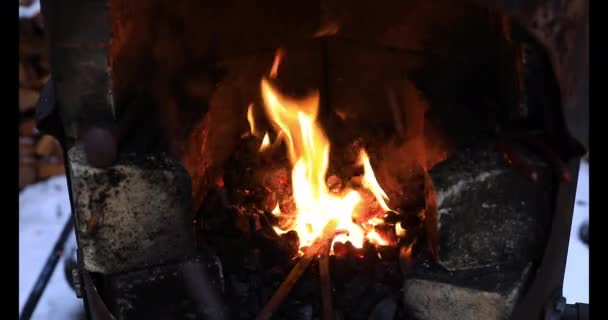 Iron rod burning in forge outside in winter — Stock Video