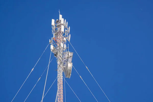 Communication antenna tower in blue sky background