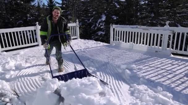 Rimozione di neve fresca da un tetto in una giornata invernale soleggiata — Video Stock