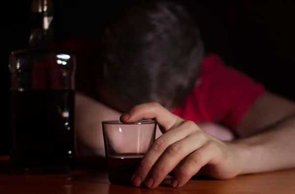 Drunk man asleep at a table Stock Image