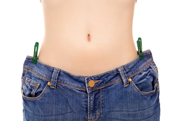 Beautiful young woman with big jeans — Stock Photo, Image