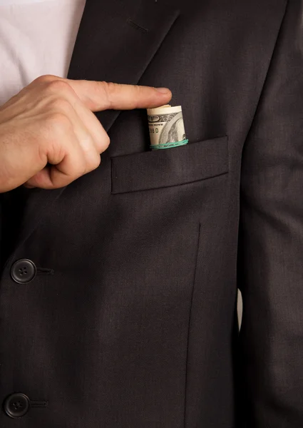 Businessman puts a bribe in his pocket — Stock Photo, Image