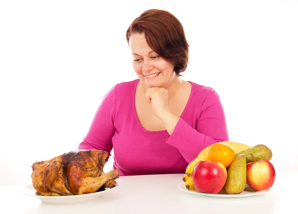 Full woman chooses what to eat — Stock Photo, Image
