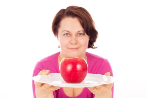 Full woman offers apple — Stock Photo, Image