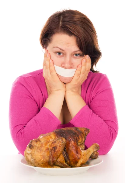 Full woman on a diet, want to eat chicken — Stock Photo, Image