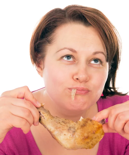 Full woman greedily absorbing piece of chicken — Stock Photo, Image