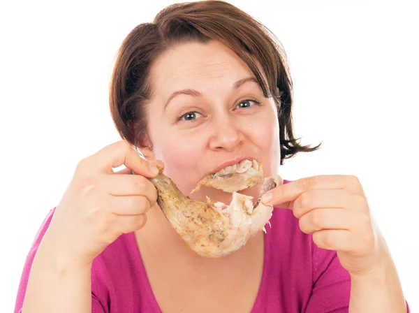 Full woman greedily absorbing piece of chicken — Stock Photo, Image