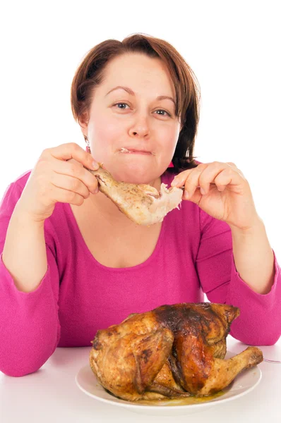 Full woman greedily absorbing piece of chicken — Stock Photo, Image