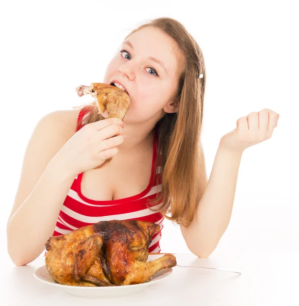 Girl greedily absorbing piece of chicken — Stock Photo, Image