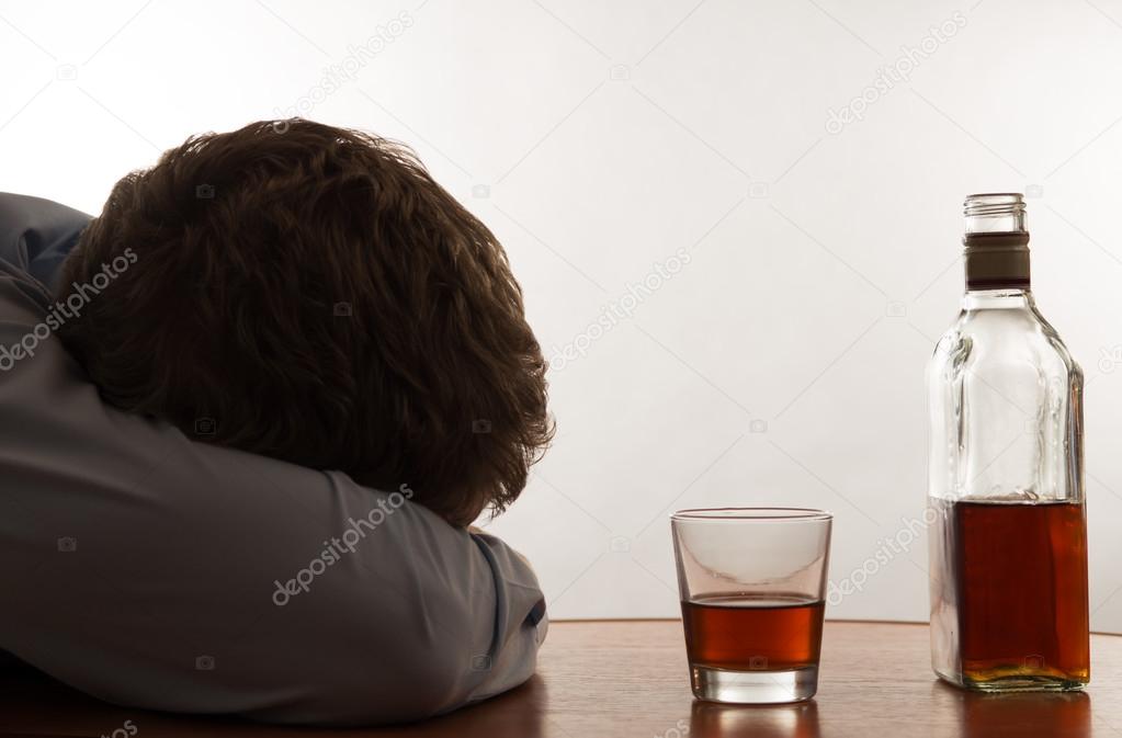 A drunk man is asleep at the table