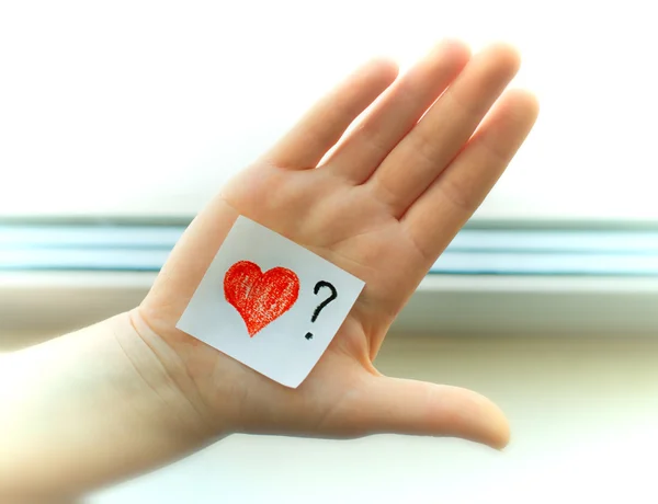 Girl holds painted a heart in his hand — Stock Photo, Image