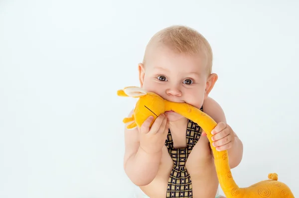 Retrato de um bebê mordendo brinquedo — Fotografia de Stock