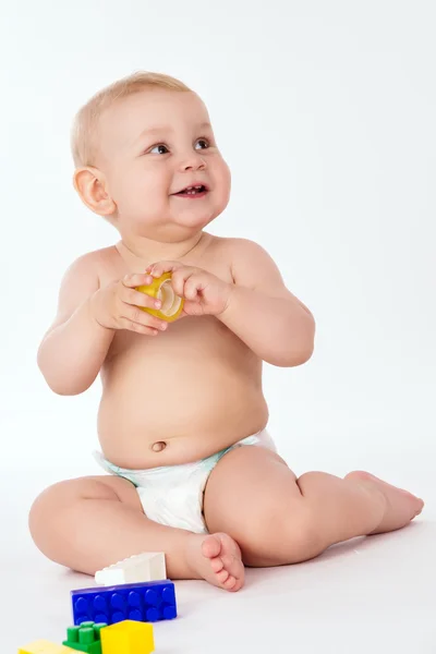 Little boy playing with toys sitting Royalty Free Stock Images