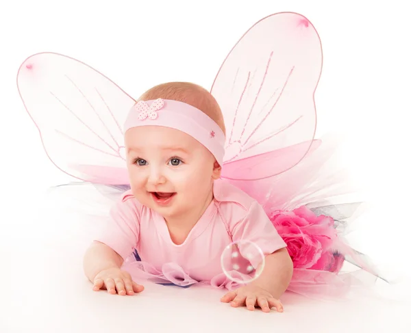 Happy small girl butterfly wings plays on the floor Stock Photo