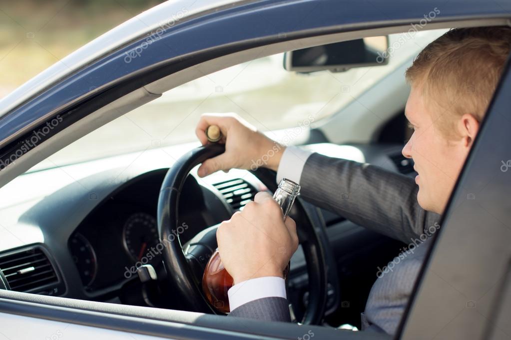 Driver sitting behind the wheel of drinks