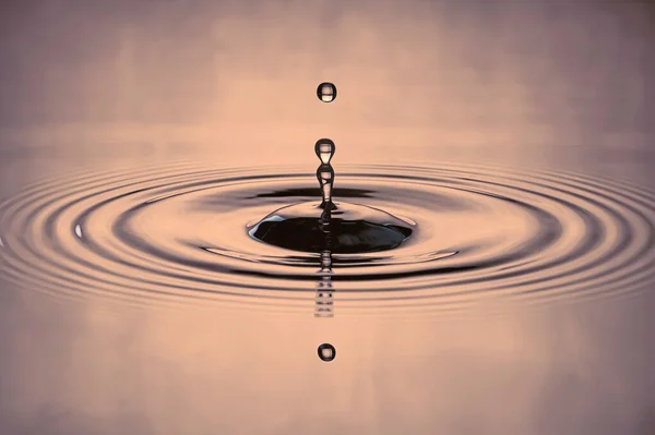 water drop splash in a gray-colored shot of water that is dripping and reflecting water.In the mist onsen pond.