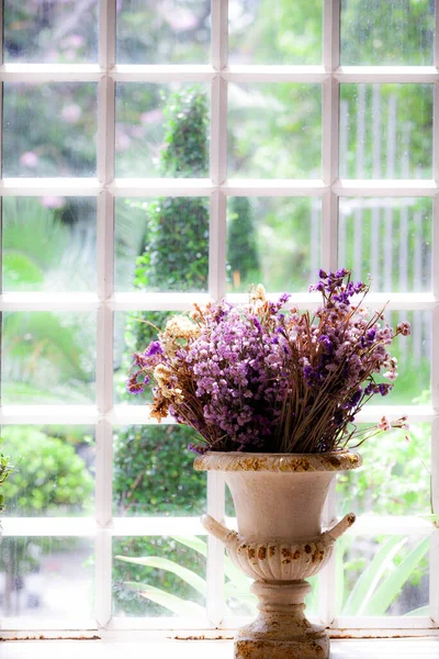 vase of dried flowers located by the window.soft focus.vintage style.