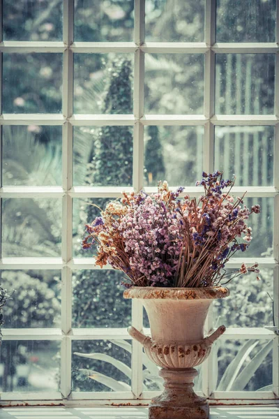 vase of dried flowers located by the window.soft focus.vintage style.