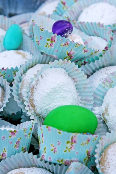 Ovos coloridos e biscoitos em pó em copos de papel azul com desenhos — Fotografia de Stock