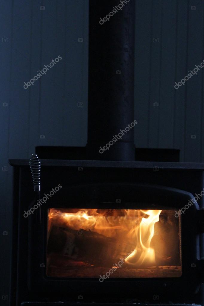 Burning logs in wood stove at night — Stock Photo © Nadine123 59832893