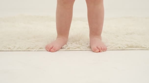小女孩的脚踩在白地毯上特写 慢动作 — 图库视频影像