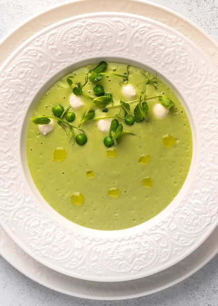 Vertical view homemade soup puree of green peas, coconut milk with mini mozzarella cheese — Stock Photo, Image