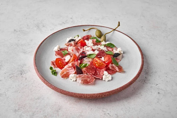 Prosciutto coppa di parma ham slices with ricotta cheese, tomato, capers — Stock Photo, Image