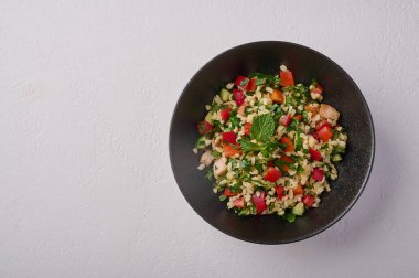 Bulgur, kuskus, kümes hayvanları, maydanoz, nane, limon, domates gibi geleneksel salata tabulesi.