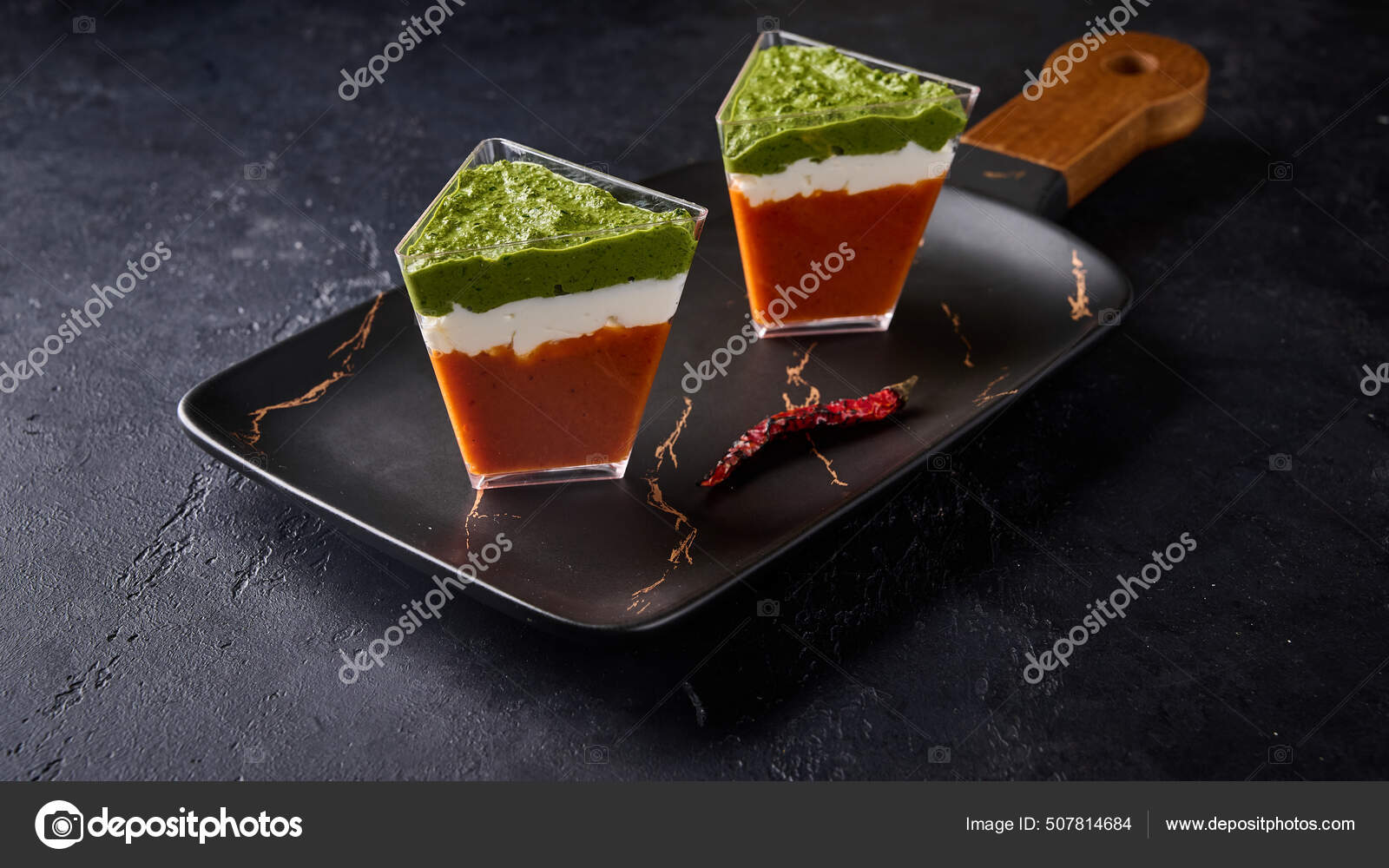 Verrines from baked pepper with gorgonzola and pesto in transparent buffet  shape cup on black rectangular dessert plate Stock Photo by ©Vit57r  507814684
