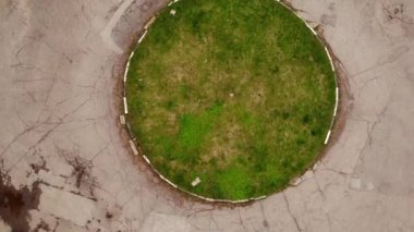 Yuvarlak çimlerde hava manzarası. Yuvarlak yol yukarıdan aşağıya havadan çekilmiş. Yeşil park alanı zemin katta görüldü. Simgesel değişimin ayrıntıları