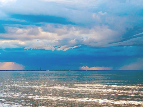 The Baltic Sea at sunset, stormy dramatic clouds. Sunset and dark clouds after storm. The Vacation, summer concept