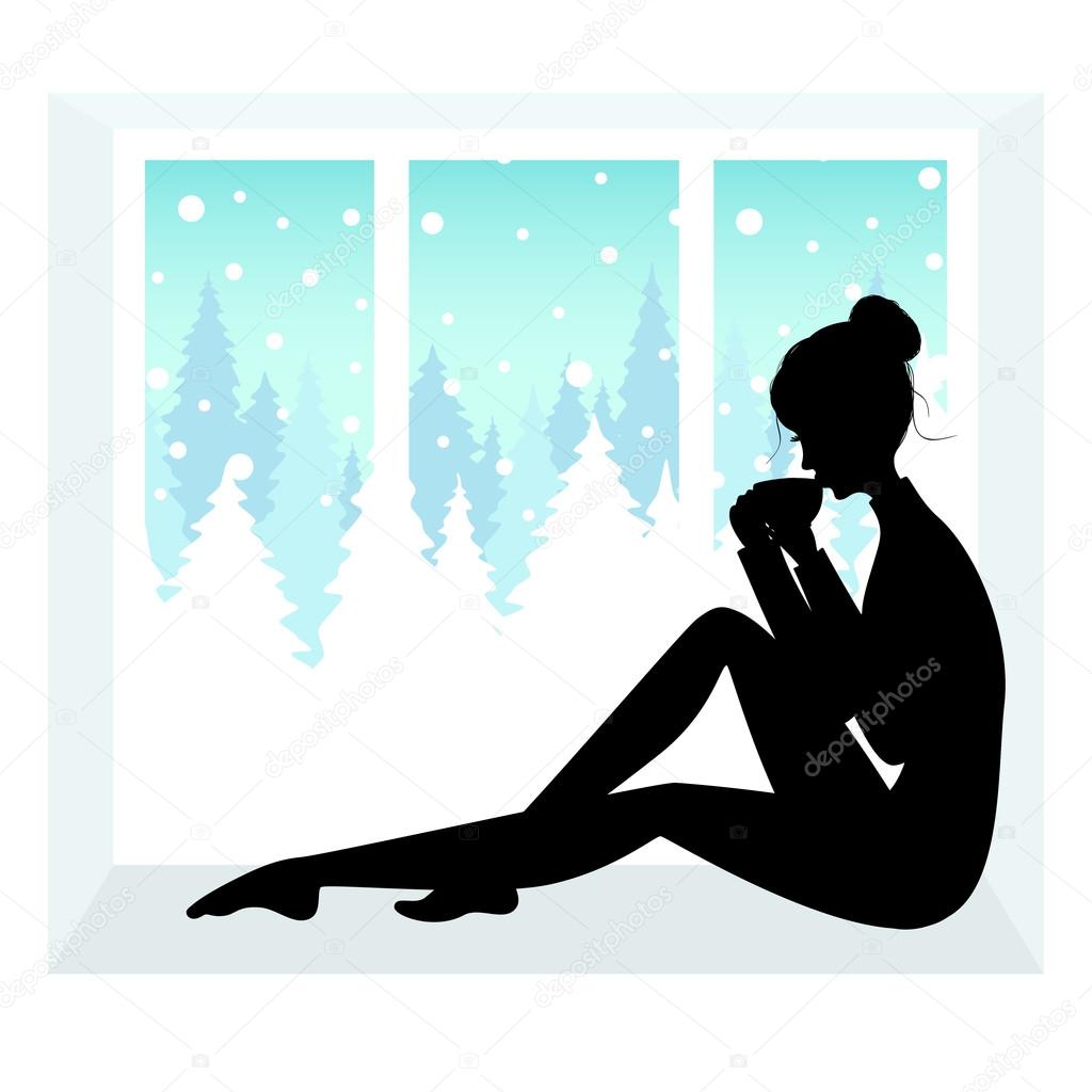 Silhouette of young woman sitting near window