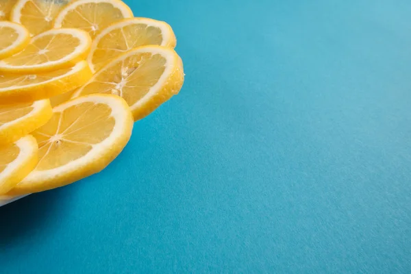 Fresh lemon lies on a blue textured background