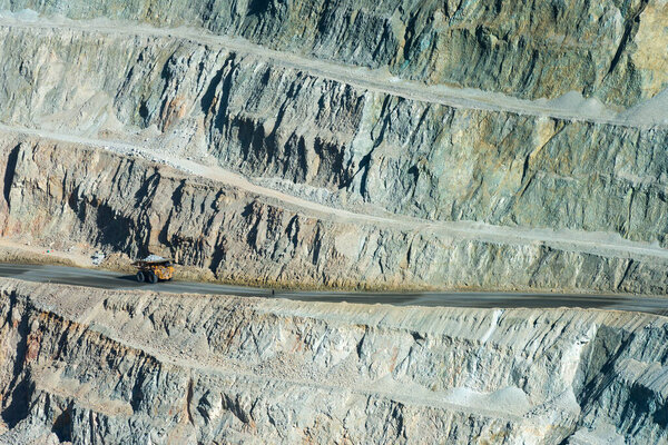 A huge dump truck in a dirt road on the pit of a copper mine in Peru